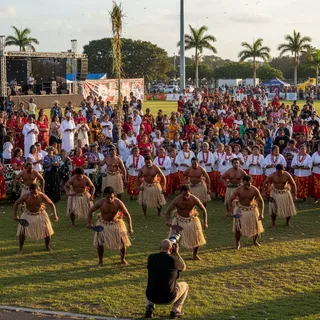 Dynamic action shot of Tokelauan people celebrating culture at a festival in Auckland, New Zealand.